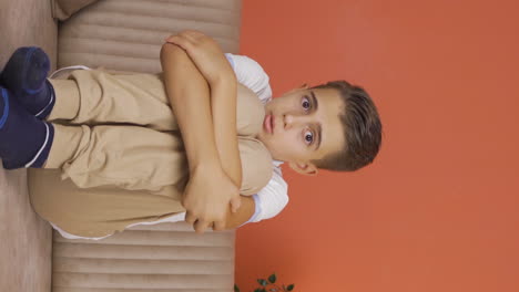 Vertical-video-of-Boy-afraid-alone-at-home.